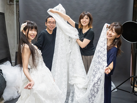 モデルの大川さんにはウェディングドレスに着替えてもらい、みんなで床にチュールを敷き詰めます